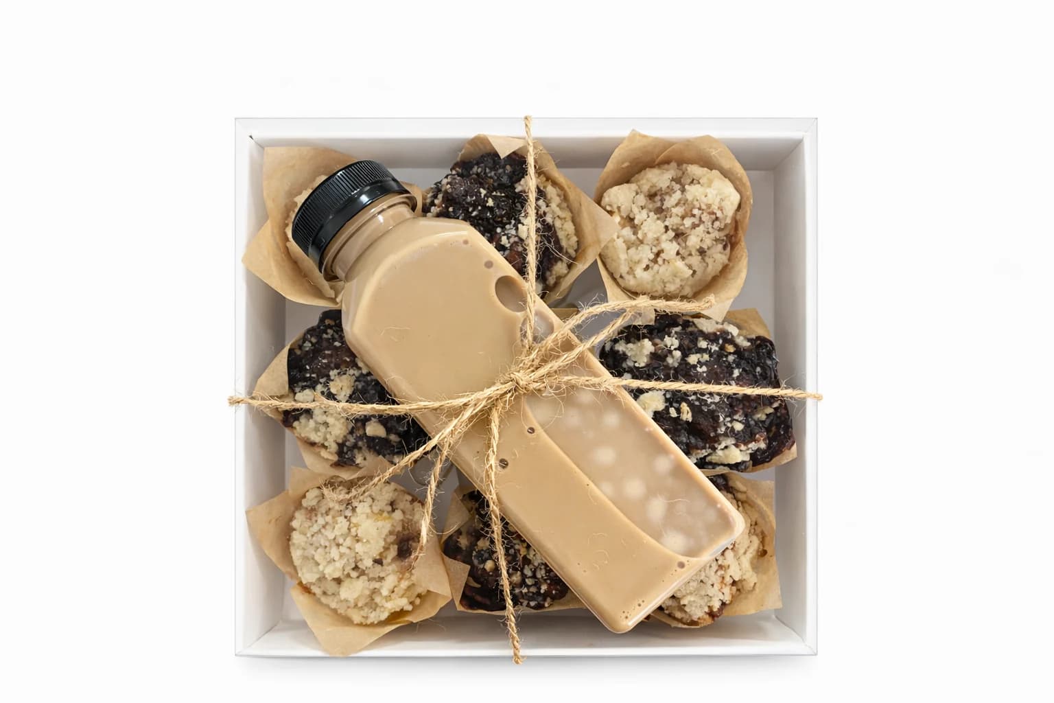Babka muffins and bottled iced coffee arranged in a clear gift box