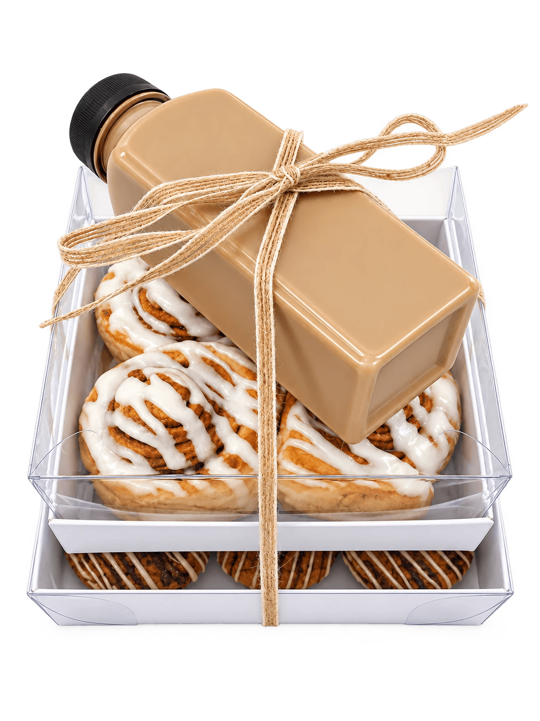 Stacked Sugar and Crumbs gift boxes of cinnamon buns, cookies and bottled iced coffee ready to send to seminary