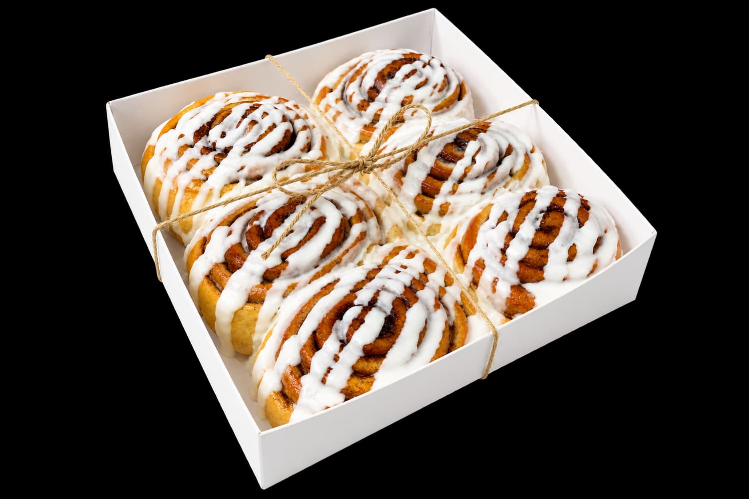 Six freshly iced cinnamon buns tied in a Sugar and Crumbs gift box